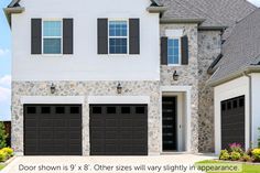 two garage doors are open in front of a white brick house with black shutters