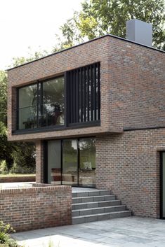 a brick building with stairs leading up to the top floor and windows on each side