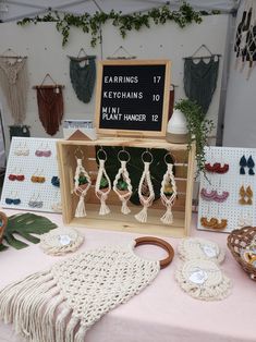 a table topped with lots of earrings next to a chalkboard that says earrings 17