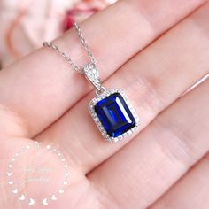 Unique on Etsy!  This is a beautiful necklace with a stunning Royal Blue coloured lab created genuine sapphire centre stone!  ''Hand made 3-carat eq. (7*9 mm) Royal Blue emerald cut lab created sapphire pendant, halo design with diamond simulants, comes with chain. '' When we first saw the finished sapphire cut we were over the moon! Our lab grown sapphire has the same chemical composition (mineral corundum), optical appearance and physical characteristics (Mohs scale 9) as top quality natural s Sapphire Jewelry Necklace, Physical Characteristics, Blue Emerald, Blue Sapphire Necklace, Mohs Scale, Halo Design, Silver Jewelry Necklace, Halo Pendant, Diamond Simulant