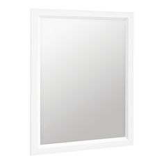 a white framed mirror sitting on top of a wall