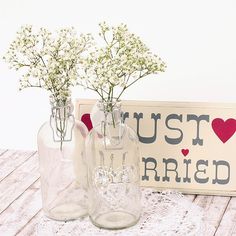 three vases with baby's breath flowers in them are sitting on a table