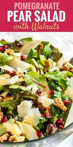 a salad with pomegranate, pears and walnuts in a glass bowl