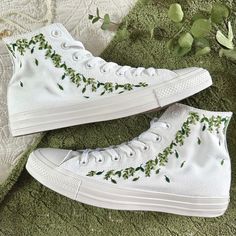 Fresh all white monochrome high top All Star Converse delicately hand embroidered with an abundance of green leaves surrounded by trailing eucalyptus. Optional extras include embroidery to the heel of the shoe and/or a matching floral posy on the front tongue of the shoes. Each pair is hand made to order and stitched with high quality embroidery thread which is washable and fade resistant.  If you're looking for something a little more bespoke, I offer a limited number of fully custom hand embroidered trainers tailored to your wishes. Consider your wedding theme, your favourite flowers, your bouquet and more all tailored to your budget. We can work together to create something perfect for you. Check out my Etsy store for the 'custom order' listing, please read item description before purch White Converse Embroidery, Embroidered Chuck Taylors, My Wish List, Wedding Trainers, Floral Wedding Shoes, Converse Embroidery, Converse Design, Cute Converse Shoes, Embroidered Converse