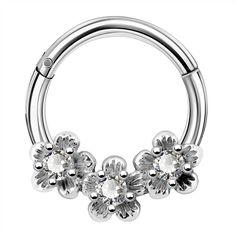 an image of a piercing ring with flowers on the end and clear crystal stones in the middle