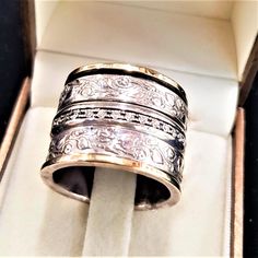 9K Gold and Silver Spinner Ring with Zircons and Flowers Decoration. In This Ring, 3 Spin Rings: 1 Stud with Zircon Stones & 2 Decorated Hammered Sterling Silver 925. Description: ❇ Free worldwide shipping ❇ Material: 925 Sterling Silver combined with 9K Solid Gold & Zirconia Stones. ❇ Bands Width: 1.7cm (0.66 inches). . ❇ All Jewelry items are shipped inside a fancy gift box. ❇ All of my designs are HANDMADE. New !! Now you can engrave your beloved's one name with a laser in the inner s Jewish Wedding Rings, Gold And Silver Ring, Wide Wedding Rings, Floral Wedding Ring, Black Tourmaline Ring, Two Tone Ring, Unique Wedding Ring, Flowers Decoration, Wide Band Ring