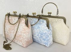 Dimension:   Length(10in) x Width(3in) x Height(7.5in) A beautiful stylized purse which is unique and currently in fashion. The purse comes in sky blue and white in color with a white floral lace overlay. The purse has a kiss lock closure. The purse looks stylish, elegant, and expensive. It is medium and large in size. It is both popular and functional. It has plenty of room to store your personal items and change. The purse opens and closes at the top middle where a round sphere kiss lock closure is seated. This is a hot item because it is elegant and makes a fashion statement. The medium purse come sieht a chain while the large purse comes with a round handle and a chain that can be connected on the inside. It can be used in weddings and for special events. It is Yi's Exclusive design en Lace Purse, Rose Purse, Bride Bag, Wedding Handbag, Bridal Handbags, Bridal Purse, Purse White, Floral Handbags, Wedding Purse