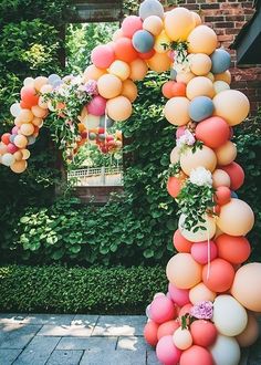 an arch made out of balloons and flowers