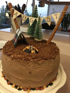 there is a cake that has been decorated with flags and trees on top of it