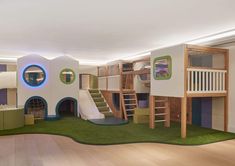 a child's bedroom with a slide and play area in the middle of it