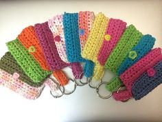 a bunch of crocheted keychains sitting on top of a white table