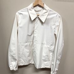 Brand New With Tags, White Nylon Jacket By Helmut Lang And Parley Collaboration. Tonal Snap Buttons, Elasticized Cuffs, Logo Subtly Stamped On Chest And Backside. Suspender Detailing Inside. Chest : 21.3” Length: 28.3” Shoulders: 17.7 Sleeves: 26” Classic Cotton Windbreaker For Work, Classic Collared Windbreaker With Pockets, Cream Windbreaker With Pockets For Fall, Classic White Cotton Utility Jacket, Classic White Utility Jacket For Work, White Windbreaker For Workwear In Winter, Classic White Long Sleeve Utility Jacket, White Winter Windbreaker For Work, White Cotton Outerwear With Lapel Collar