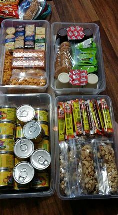 four plastic containers filled with food sitting on top of a wooden table next to each other