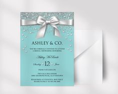 a blue and silver wedding card with a bow