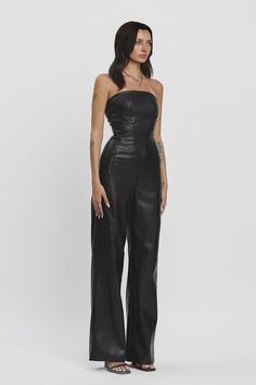 Step into sophistication with the Starlit Muse Jumpsuit. This stylish strapless jumpsuit features a fitted tube top that beautifully enhances your silhouette, while wide-legged pants create an effortlessly chic look. With convenient zipper pockets and a back zipper closure, this piece combines functionality and fashion. Crafted from high-quality faux leather with good stretch, it's perfect for an evening out or any occasion where you want to stand out. Pleather Jumpsuit Stretch Strapless Color b Strapless Jumpsuit, Black Model, Good Stretches, Fall Collections, Black Jumpsuit, Tube Top, Summer Collection, Party Wear, Jumpsuit Dress