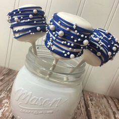 blue and white cake pops in a mason jar