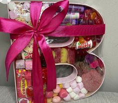 a heart shaped box filled with candy and candies