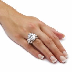 a woman's hand with a diamond ring on it