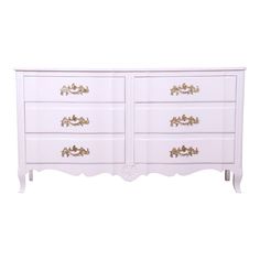 a white dresser with gold handles on it's sides and drawers, against a white background