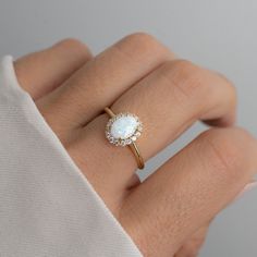 Beautiful opal ring featuring an oval cut with a pavé halo. It is absolutely stunning!  - - - D E T A I L S - - - * Made of 925 Sterling Silver * We use a THICK, DURABLE 14k Gold, Rose Gold, or Rhodium plating - for a piece that will last you years to come! * Lab Created Opal- we use the highest grade for an authentic look * VERY HIGH QUALITY * Nickel-free & Hypoallergenic * Available in sizes 4-10 * Opal Stone w Halo: 10mm  Ring Sizer- https://www.etsy.com/listing/1240904225/ring-sizer-reusable-ring-sizer-plastic?click_key=61e9f4f91cda17e59794f2a68a822a251ab4529d%3A1240904225&click_sum=ffc40ac5&ga_search_query=ring%2Bsizer&ref=shop_items_search_2&pro=1 Made with 100% Pure Love! ♡ Happy to answer any questions you may have! 🥰 Let's Connect! 🥰 IG: samijewels_ Simple Opal Engagement Ring, Classic Opal Ring, Wedding Ring Opal, Senior Rings, Opal Birthstone Ring, Antique Opal Ring, Dainty Opal Ring, Opal Ring Silver, Opal Engagement Rings