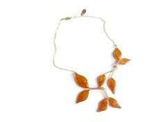 This Pearl Rose Gold Leaf Necklace has leaves hand formed in bronze with 14k gold filled chain and components. Each leaf is filled with a hand mixed pearl rose gold resin inlay. Inspired by fall colors and the crisp autumn air, this necklace captures the leaves of fall for year-round wear. Anthos, which means flower in Greek is my collection inspired by nature. Each leaf and petal is delicately assembled to form a striking piece of statement jewelry that is one of a kind and lays lightly on your Elegant Amber Resin Jewelry, Elegant Copper Leaf Jewelry, Elegant Orange Resin Jewelry, Delicate Gold Resin Jewelry, Gold Leaf-shaped Copper Jewelry, Gold Resin Nature-inspired Jewelry, Nature-inspired Gold Resin Jewelry, Gold Floral Necklace, Leaf Necklace Gold