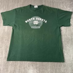 Vintage 2000s North Dakota University College Basketball Sportswear Athletic Y2K Aesthetic Green Graphic T Shirt Extra Large Mens Condition:  Fair Used Condition  = Flaw On The Back Of The Shirt Due To Age And Wear  Measurements: Please see photos above for all measurements IF YOU BUY TWO OR MORE ITEMS USE THE CODE BUNDLE @ CHECK TO SAVE 20% WE SHIP WITHIN 24 HOURS AFTER PURCHASE! Please be aware that we do not offer free returns!! The Buyer is responsible for the cost of the return label.  Foll 90s Style Short Sleeve Sports T-shirt, Green Casual T-shirt For Sports Events, Y2k Short Sleeve Tops For Sports, Green Sports T-shirt With Letter Print, 90s Logo Print Sports Top, 90s Logo Print Tops For Sports Events, 90s Style Sports Event Logo Print Tops, 90s Logo Print Tops For Sports Season, 90s Style Tops For Sports Events