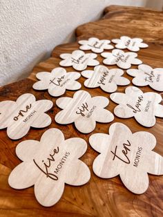 wooden hearts with names on them sitting on a table