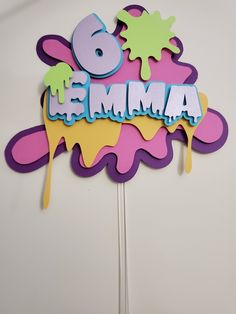 a birthday cake topper with the number six on it