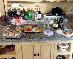 a kitchen counter topped with lots of food and wine bottles next to a stove top oven