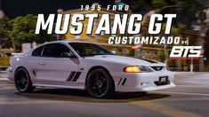 a white mustang gt car driving down a street at night with the words mustang gt customizado on it