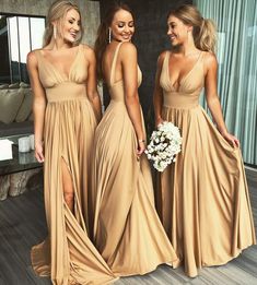 three women in long dresses standing next to each other