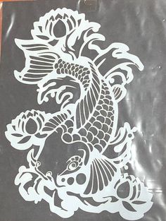 a black and white drawing of a koi fish on a piece of clear plastic