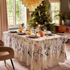 a dining room table is decorated for christmas