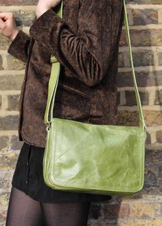 The Denise bag in apple green leather measures 28x20x8cms. The base width is 8cms. It has six compartments in total and the lining is black and waterproof. This bag is reinforced by rivets on the side allowing you to carry a good deal of weight. The multi-compartments make this bag extremely practical for everyday use! The back compartment measures 24cms x 14cms. The internal zip is 17 x 14cms. The main zip is 25cms x 19.5cms. The under flap zip compartment measures 19x15cms. The magnet pocket is 25 x 11cms. The width of the strap is 2.5cms, and the length is 132cms fully adjustable. Green Satchel Briefcase For Travel, Modern Green Shoulder Bag With Leather Lining, Green Rectangular Leather Bag, Green Rectangular Briefcase, Green Shoulder Bag For Business, Classic Green Rectangular Satchel, Green Leather Satchel Shoulder Bag, Green Soft Leather Flap Shoulder Bag, Green Satchel Shoulder Bag With Leather Lining