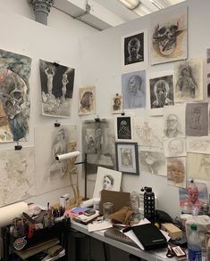 an art studio with lots of drawings on the wall