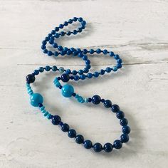 Vintage Lapis Lazuli Azurite Turquoise Long Beaded Necklace 28in Gorgeous Colors! It is composed of lapis lazuli, turquoise, and azurite round beads with small stations of turquoise pebbles for interest. This necklace is 28" long and has no clasp, and it slips over the head. The beads at the front center are 8 mm, followed by the small pebbles. The large turquoise rounds are 13.5 mm in diameter and flanked by 4mm round lapis beads. Above those, there is a 10mm round lapis bead on each side. The Round Lapis Lazuli Beads With Natural Stones, Lapis Lazuli Beads With Natural Stones, Turquoise Lapis Lazuli Beaded Necklace With Polished Beads, Bohemian Single Strand Lapis Lazuli Beaded Necklace, Bohemian Blue Turquoise Necklace With Round Beads, Bohemian Blue Turquoise Beaded Necklace, Bohemian Blue Turquoise Necklace, Bohemian Blue Round Beads, Turquoise Lapis Lazuli Beaded Necklace With Round Beads