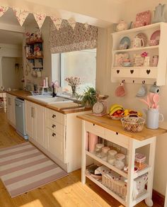 a kitchen filled with lots of counter top space and wooden flooring next to a window