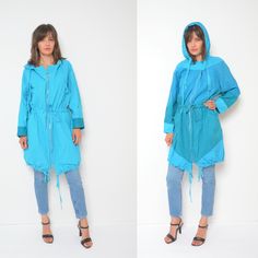 "80s hooded zipper oversized jacket. Colorful tie waist light coat. Spring summer festival wear. - Label: n/a - Era: 1980's - Color: light blue , green - Fabric: 100% cotton - Condition: very good. Ready to wear. - Tag Size: - Fits: large MEASUREMENTS: *Bust: 51.2\" (130 cm) *Waist: 44.8\" (114 cm) *Sleeve Length (from the armpit to the wrist): 16.5\" (42 cm) *Length: 36.6\" (93 cm)" Oversized Hooded Spring Windbreaker, Oversized Hooded Windbreaker For Spring, Spring Oversized Parka With Adjustable Hood, Oversized Parka With Drawstring Hood For Spring, Oversized Hooded Summer Outerwear, Spring Streetwear Hooded Parka, Blue Hooded Parka For Spring, Blue Long Sleeve Parka For Spring, Blue Spring Parka