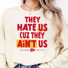 Our Kansas City Chiefs Shirt is perfect for fall football! Our Vintage Chiefs Shirts have a funny design that everyone in Chiefs Kingdom will love:  **They Hate Us, Cause They Ain't Us** KC Chiefs fans know we are in our villain era! Other NFL teams hate on the Chiefs because of #15 Patrick Mahomes and #87 Travis Kelce. We created this Kansas City Travis Kelce tee with our favorite quarterback and tightend in mind.Our  **They Hate Us, Cause They Ain't Us** shirts come in Ivory and Red. **Comfort Colors Unisex Garment-dyed Long Sleeve T-Shirt** Made with 100% ring-spun cotton, the Comfort Colors 6014 Unisex Garment-dyed  Long Sleeve T-Shirts come packed with softness and style. Each tee features garment-dyed fabric and comes with a relaxed fit for total comfort in any casual setting.  .: 10 Fan Apparel Tops With Slogan, Slogan Tops For Fans, Long Sleeve Letter Print Football T-shirt, Funny Crew Neck Tops For College, Long Sleeve T-shirt With Letter Print For Football Season, Long Sleeve Letter Print T-shirt For Football Season, Casual Slogan Tops For Fan Gear, Team Spirit Slogan Tops For Fans, Team Spirit Slogan Tops For Fan Gear