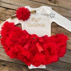 "Your little love will look adorable for her very first Christmas with our \"My 1st Christmas\" outfit. Choose which pieces you would like in the options: {BODYSUIT} Script \"My 1st Christmas\" is printed in sparkling GOLD or SILVER glitter onto a Carter's brand white bodysuit. These make perfect baby shower gifts, Christmas outfits, meeting Santa picture outfits and gorgeous photo props! Available in Newborn to 24 months in either Short Sleeve (SS) or Long Sleeve (LS). Our glitter is permanent Christmas Tutu Outfit, Christmas Photos Outfits, Red Flower Headband, First Christmas Outfit, My 1st Christmas, Christmas Tutu, Girls Christmas Outfits, My First Christmas