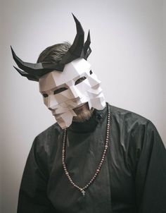 a man wearing a paper mask with horns on his head