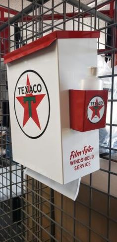 there is a sign that says texaco on the side of a cage in a store