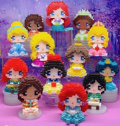 a group of beaded princesses sitting on top of each other in front of a purple background