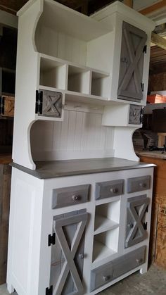 an old kitchen cabinet is painted white and gray