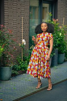 Coming through with strong and vibrant colours is red and yellow Marigold Dress, inspired by the bright and resilient Marigold flowers. With its striking red and yellow hues, this dress embodies the flower's warmth and beauty. Designed for durability and comfort, it's perfect for any occasion. Embrace the positivity and radiance of Marigolds in your attire with this radiating dress. Two side pockets Elastic band at the back.  Lined torso. Dress length is 46 inches for size S to L, 47 inches for Yellow Bohemian Knee-length Midi Dress, Torso Dress, Multicolor Vibrant Print Knee-length Dress, Spring Yellow Midi-length Shirt Dress, Yellow Cotton A-line Midi Dress, Marigold Dress, Yellow Marigold, Yellow Floral Print Non-stretch Dress, Marigold Flowers