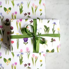 two wrapped presents with flowers on them