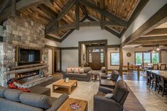 a living room filled with furniture and a fire place in the middle of a room