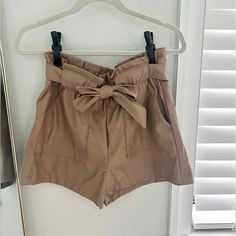 Brand New, With Tags! Never Worn! Ci Sono Premium Faux Leather Paperbag, High Waist Shorts With Cargo Pockets, Tie Detail In Cappuccino (Tan). Size Medium Casual Bottoms With Pockets For Going Out, Paperbag Waist Shorts With Pockets For Work, Workwear Shorts With Pockets And Paperbag Waist, Going Out Shorts With Belt Loops, Trendy Brown Shorts For Day Out, Khaki Paperbag Waist Bottoms For Day Out, Beige Paperbag Waist Shorts For Workwear, Short Bottoms With Belt Loops For Going Out, Chic Khaki Shorts For Day Out