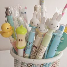 a cup filled with lots of different types of pens