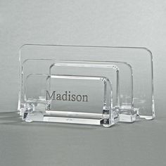 three clear acrylic business card holders with the word madison on them, sitting side by side